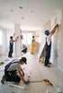 Workers applying wall plaster